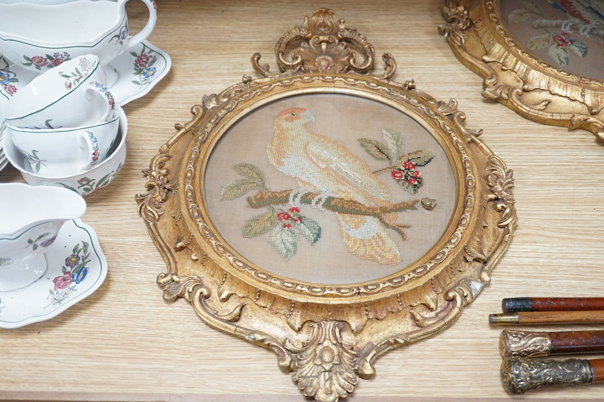 A pair of 19th century giltwood framed circular needleworks of parrots, 26cm diameter excl frame